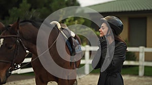 A young woman is preparing for horse competitions