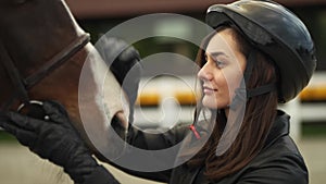 A young woman is preparing for horse competitions