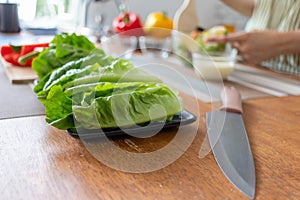 young woman preparing lettuce As an ingredient in breakfast menu and ready for cooking healthy meals and on table there are also