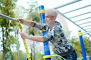 Young woman is preparing Sports Equipment  outdoors. in the park.