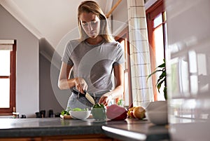 Young woman preparing vegan dinner