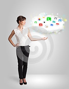 Young woman presenting cloud with colorful app icons and symbols