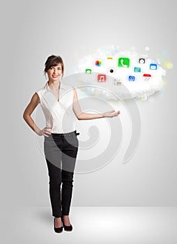 Young woman presenting cloud with colorful app icons and symbols