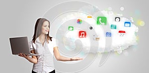 Young woman presenting cloud with colorful app icons and symbols