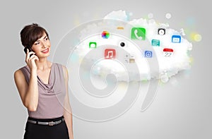 Young woman presenting cloud with colorful app icons and symbols