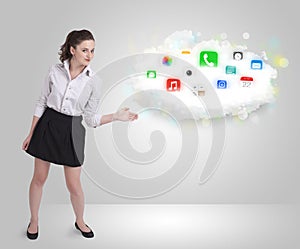 Young woman presenting cloud with colorful app icons and symbols