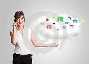 Young woman presenting cloud with colorful app icons and symbols