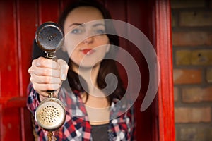 Young woman presenting a telephone handset