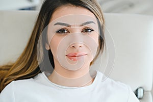 Young woman during professional eyebrow mapping procedure.