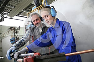 Young woman in professional plumbery training