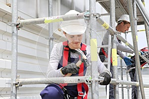 Young woman in professional training scaffolding