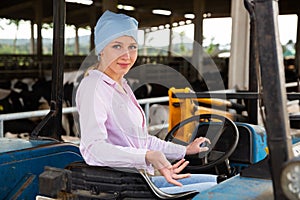 Young woman proffesional farmer is sitting in the car at the farm