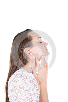 Young woman profile touches her neck in white background