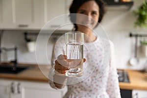 Young woman propose to start morning from glass of water