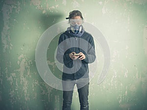 Young woman in protective gear using smart phone