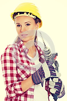 Young woman in protective helmet and jackhammer.