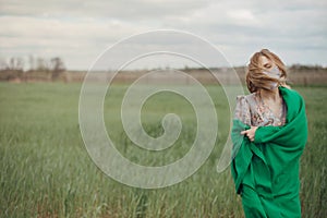 Young woman in protective mask in field. Lady quarantine in the village. Girl and quarantine . Covid-19. Europe