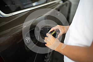 Young woman pumping gas at gas pump