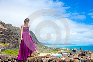Young woman in purple dress at scenic Makapu'u viewpoint, Hawaii
