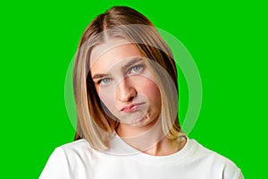 Young Woman With Pursed Lips Expressing Skepticism Against Green Screen Background