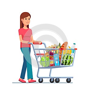 Young woman pushing supermarket shopping cart