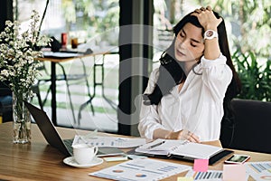 young woman put hand on head feeling tired, frustrated & stressed from hard work at office. exhausted businesswoman have headache