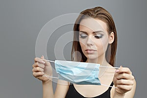 Young woman put on medical mask