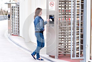 Young woman puts the card into the reader system