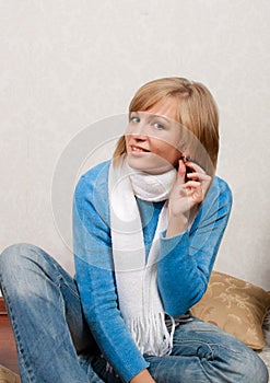 Young woman puts on ear-rings