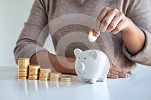 Young woman putting coins into piggy bank planning growing saving to strategy with money box for future plan fund of travel,