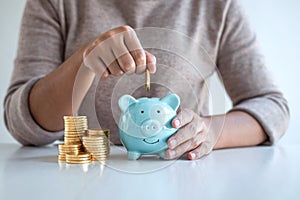 Young woman putting coins into piggy bank planning growing saving to strategy with money box for future plan fund of travel,