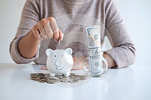 Young woman putting coins into piggy bank planning growing saving to strategy with money box for future plan fund of travel,