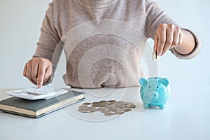 Young woman putting coins into piggy bank planning growing saving to strategy with money box for future plan fund of travel,