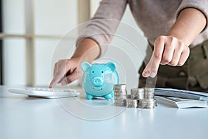 Young woman putting coins into piggy bank planning growing saving to strategy with money box for future plan fund of travel,