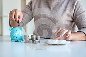 Young woman putting coins into piggy bank planning growing saving to strategy with money box for future plan fund of travel,