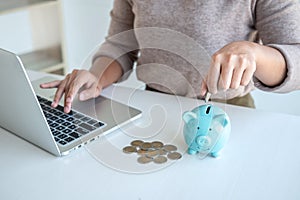 Young woman putting coins into piggy bank planning growing saving to strategy with money box for future plan fund of travel,