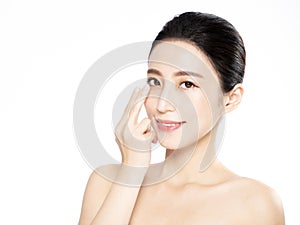 Young woman putting contact lens in her eye