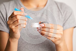 Young woman putting eye contact lens on her eyes