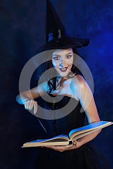 Young woman putting a spell with magic wand