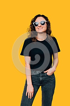 Young Woman with a Radiant Smile Wearing Stylish Sunglasses - Vertical Studio Shot
