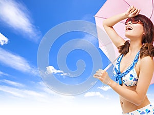 Young woman raise hand to cover sunlight with a umbrella