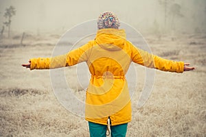 Young Woman with raised hands enjoying outdoor