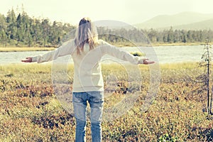 Young Woman raised hands standing alone walking outdoor Travel