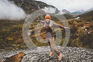 Young woman raised hands traveling in Norway