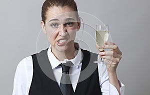 Young woman raising a glass of sharp white wine