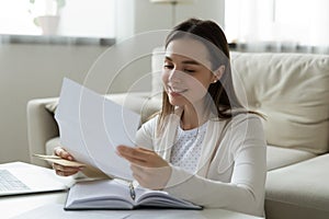 Young woman read pleasant news in paper letter