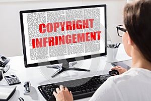 Young Woman Reading Agreement With Copyright Infringement Text photo