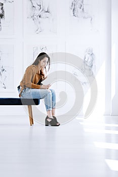 Young woman reading art guidebook