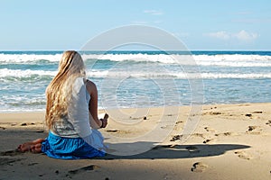 Young woman reading on beach