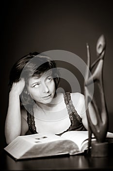 Young woman reading big book, concentration and attentiveness